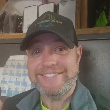 Harrison Steves, smiling, wearing a Sea Sight Survey cap